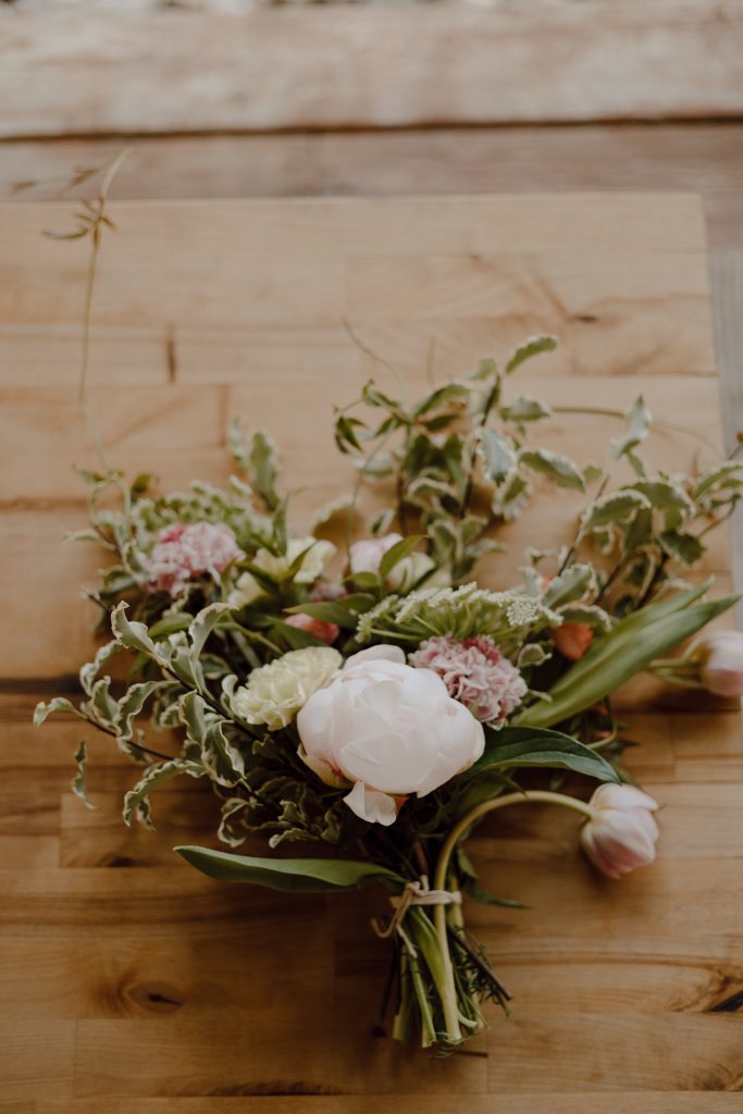 a bouquet of flowers on a wood surface