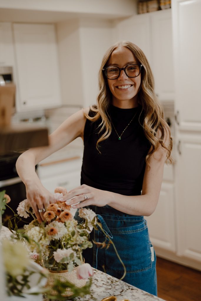 a woman wearing glasses and a black shirt