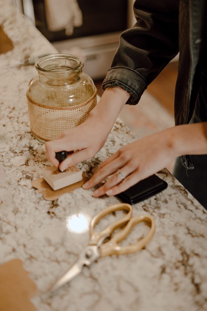 a person using a stamp to seal something on a counter