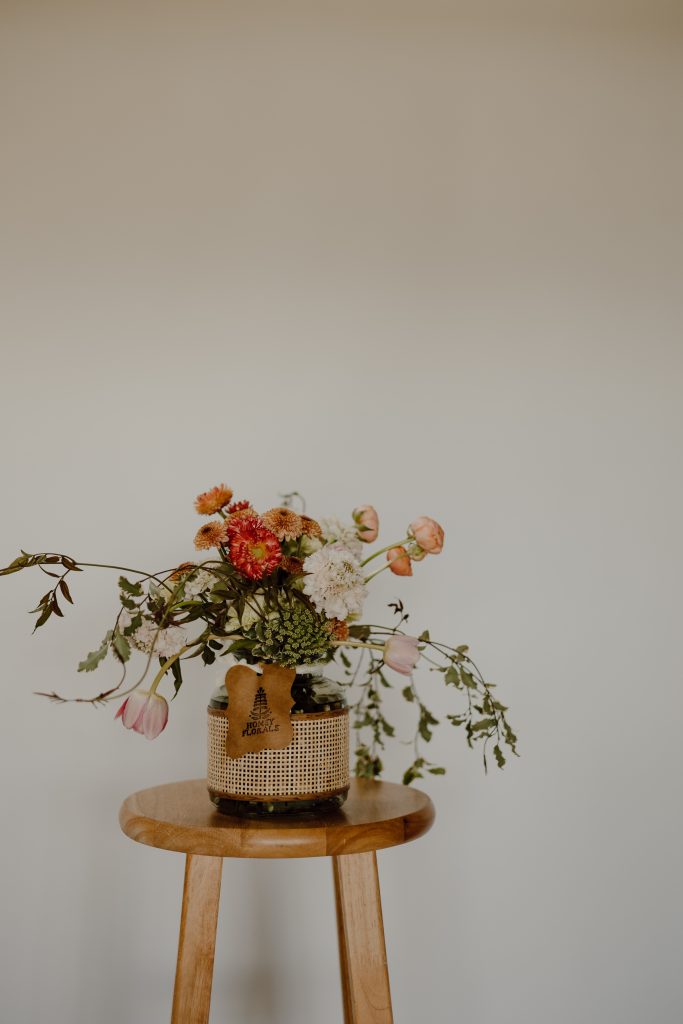 a vase with flowers on a table